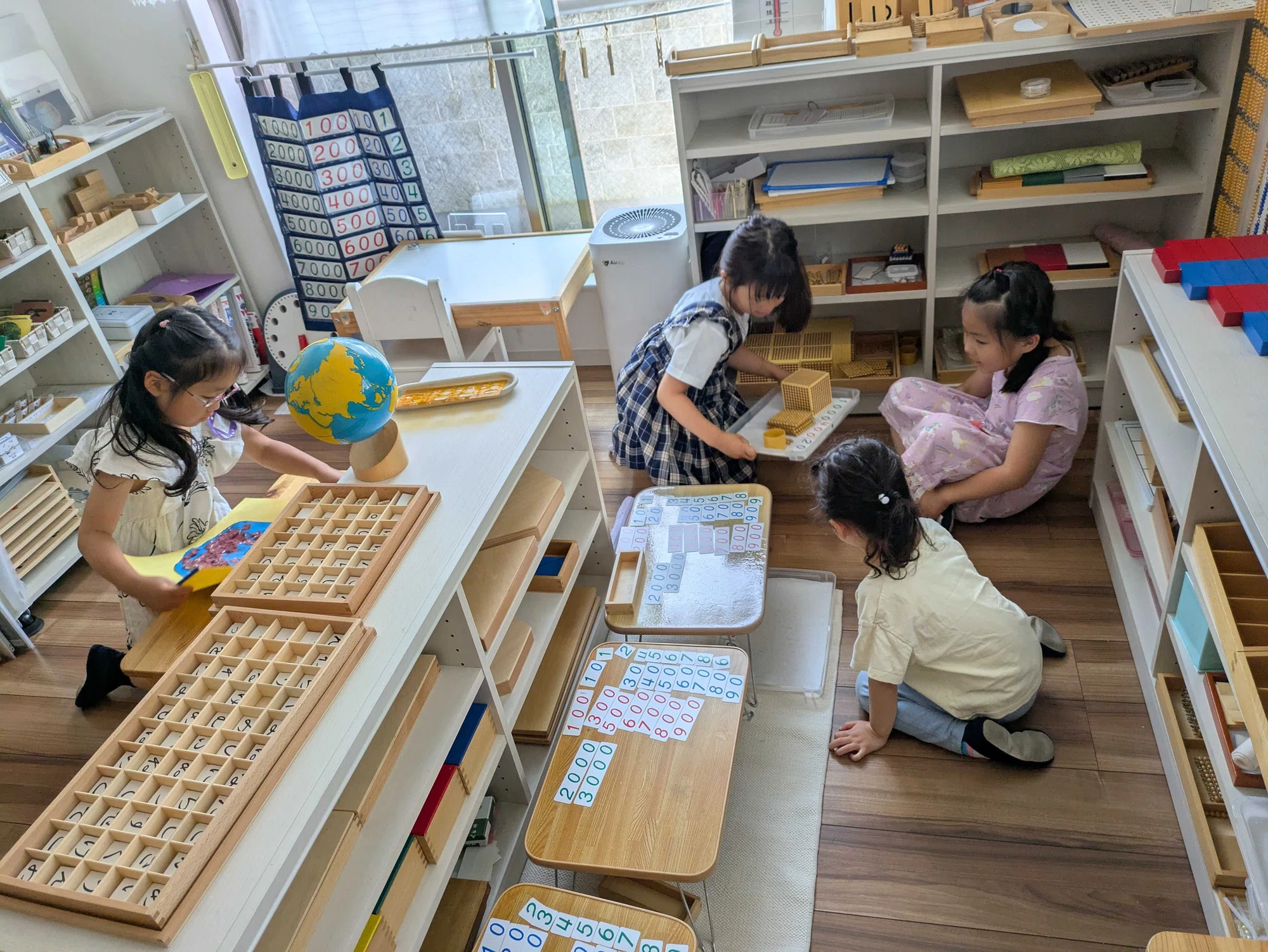 Children working with Montessori learning materials in a real classroom